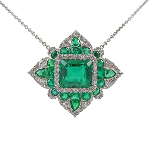 Early 20th century emerald and diamond lozenge cluster pendant, c.1910, the principal rectangular Colombian emerald of 2.92ct,